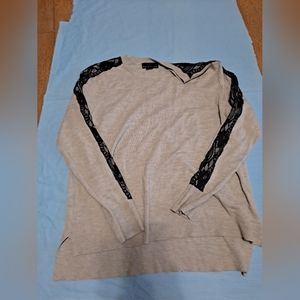 grey swetshirt with black lace fabric on the arms